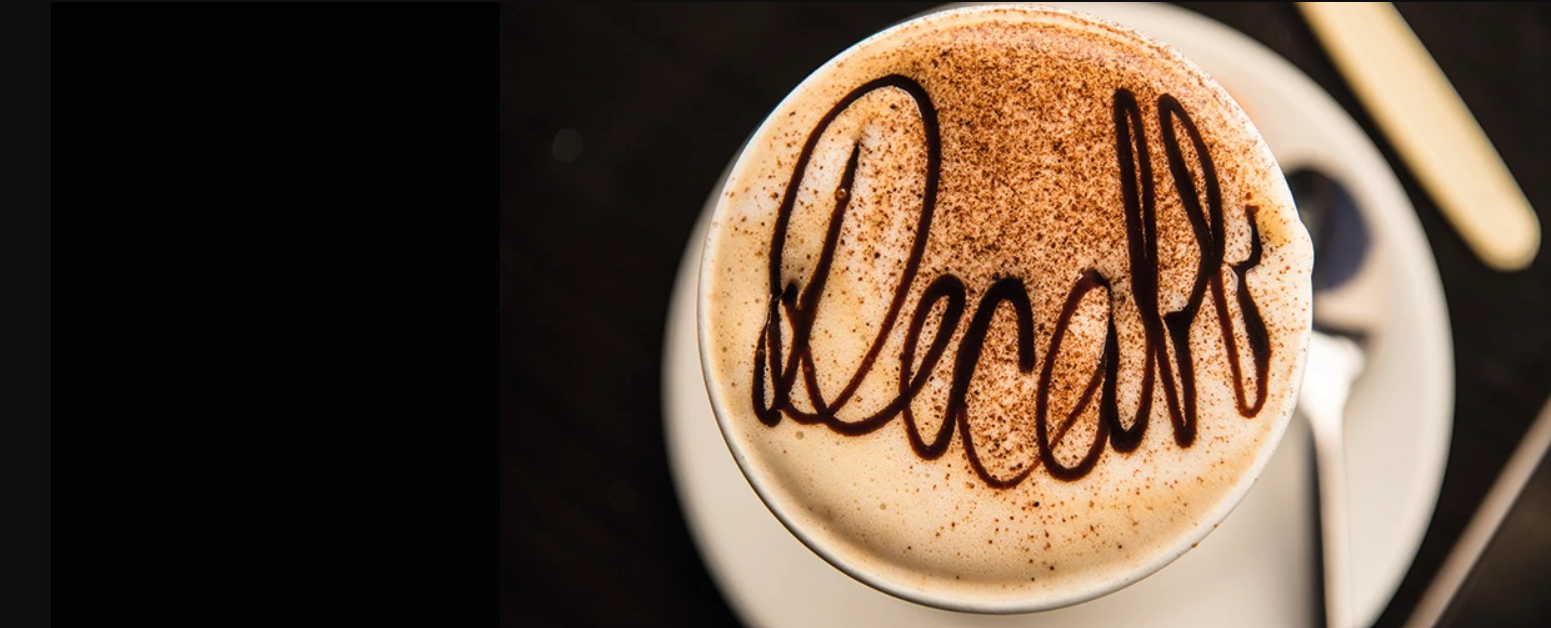 brown writing on a decaf coffee